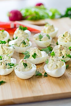 stuffed eggs, deviled eggs on a wooden table