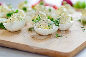 stuffed eggs, deviled eggs on a wooden table