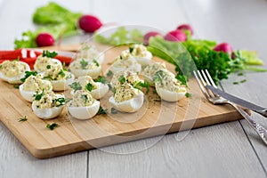 stuffed eggs, deviled eggs on a wooden table