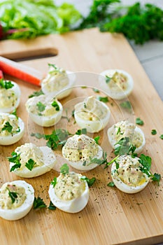 stuffed eggs, deviled eggs on a wooden table
