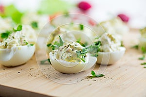 stuffed eggs, deviled eggs on a wooden table