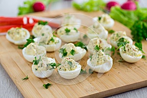 stuffed eggs, deviled eggs on a wooden table