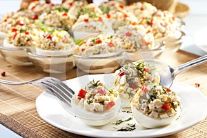Stuffed eggs with ham, red pepper and dill