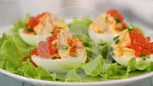 Stuffed eggs with red caviar