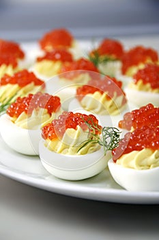 Stuffed eggs with red caviar