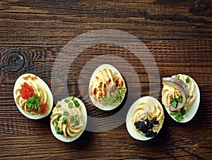 Stuffed eggs on wooden table