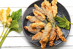 Stuffed fried zucchini flowers on the plate