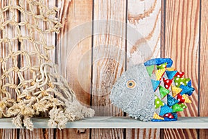 Stuffed funny fish on wooden background