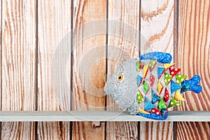 Stuffed funny fish on wooden background