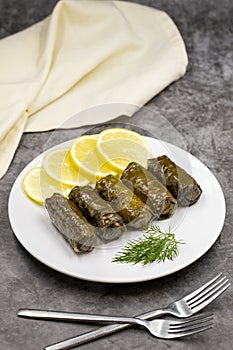 Stuffed grape leaves with olive oil on a dark background. Delicious dolma yaprak sarma.