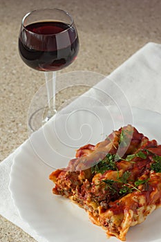 Stuffed meat cannelloni and glass of wine