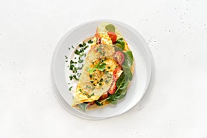 Stuffed omelette with tomatoes and spinach