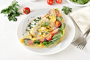 Stuffed omelette with tomatoes and spinach