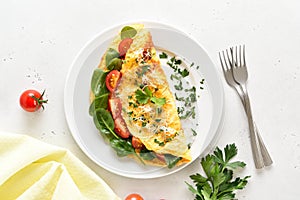 Stuffed omelette with tomatoes and spinach