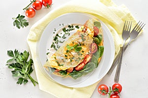 Stuffed omelette with tomatoes and spinach