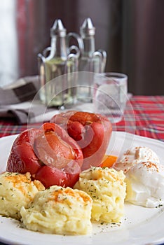 Stuffed peppers served with mashed potatoes and cream cheese called Kajmak photo