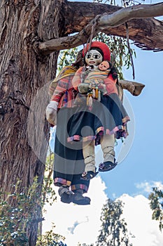 Stuffed puppets hanging on a tree at Inca`s ruins of Q`enqo near Cuzco, Per