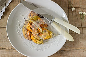 Stuffed with ricotta and cheese baked zucchini and pumpkin flowers served with a glass of mineral water. Rutik style.