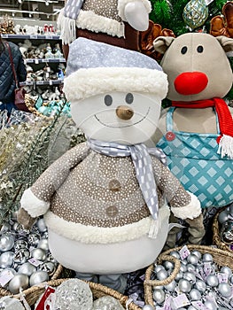 Stuffed toys, teddy snowman and deer at christmas market fair in the mall