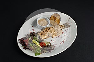 Stuffed trout with mushrooms sauce and salad