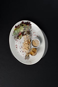 Stuffed trout with mushrooms sauce and salad