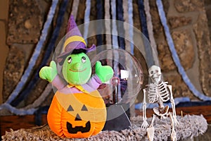 Stuffed witch inside carved pumpkin