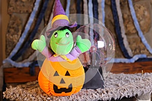 Stuffed witch inside carved pumpkin