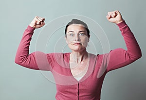 Stunned 40s woman showing her emphasized strength