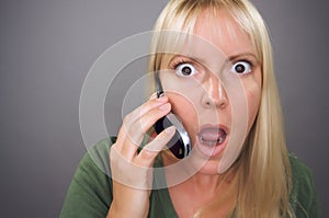 Stunned Blond Woman Using Cell Phone