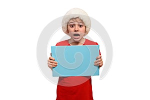 Stunned boy in Santa hats with an empty tablet in hands. Isolate on white