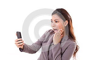 Stunned business woman receiving bad news from her smart phone