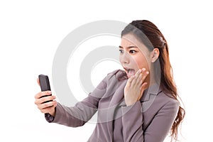 Stunned business woman receiving bad news from her smart phone photo