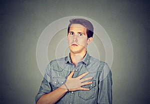 Stunned man with hand on chest