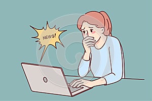 Stunned woman shocked by news on laptop