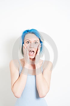 Stunned young alternative teenager woman on white portrait