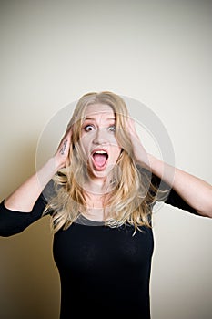 Stunned young woman on white portrait