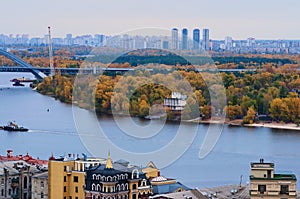 Stunning aerial autumn landscape view of Kyiv. Podil neighborhood and River Dnipro against blue sky