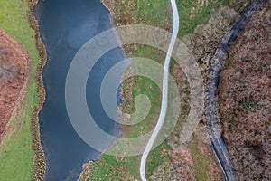 Stunning aerial drone landscape image over River Brathay near Elterwater in Lake District with Langdale Pikes in distance