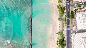 Stunning aerial drone view of Kuhio Beach, part of Waikiki Beach in Honolulu on the island of Oahu, Hawaii. The beach is protected