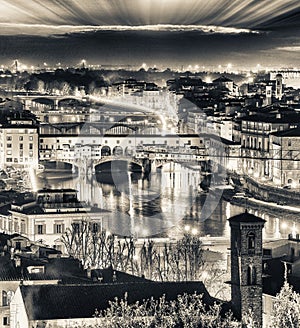 Stunning aerial night view of Ponte Vecchio, Firenze. Old Bridge and lungarni in Florence, Tuscany, Italy