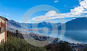 Stunning aerial panorama view of  Locarno cityscape and Lake Maggiore from Madonna del Sasso church, snow covered Swiss Alps