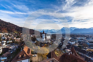 Stunning aerial panorama view of Thun cityscape and Aare river flowing to Lake Thun from Thun castle, with Swiss Alps mountain