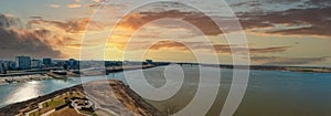 A stunning aerial panoramic shot of the vast flowing waters of the Mississippi river and Wolf Creek Harbor with skyscrapers