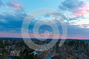 A stunning aerial shot of the blue sky with powerful red clouds at sunset