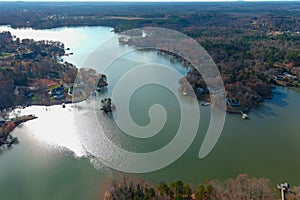 A stunning aerial shot of the Catawba River surrounded by vast miles of green and autumn colored trees in Charlotte