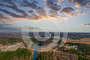 A stunning aerial shot of the Catawba River surrounded by vast miles of green and autumn colored trees with powerful clouds