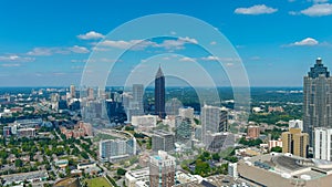 A stunning aerial shot of the city skyline with skyscrapers and office buildings and lush green trees in downtown Atlanta Georgia