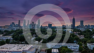 A stunning aerial shot of the cityscape at sunset with skyscrapers and office buildings in the skyline surrounded