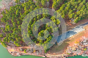 A stunning aerial shot of the silky green Catawba River surrounded by vast miles of green and autumn colored trees in Charlotte