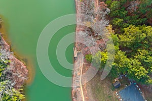 A stunning aerial shot of the silky green Catawba River surrounded by vast miles of green and autumn colored trees in Charlotte